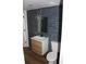 Stylish bathroom with a floating vanity, modern fixtures, and blue tiled wall at 701 1St Ne St, Fort Meade, FL 33841