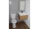 Contemporary bathroom with gray tiled walls, wood vanity, and modern fixtures at 701 1St Ne St, Fort Meade, FL 33841