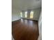 Spacious room with hardwood floors and multiple windows providing ample natural light at 701 1St Ne St, Fort Meade, FL 33841