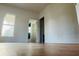 Spacious bedroom featuring light walls, wood flooring, and a window to provide natural light at 701 1St Ne St, Fort Meade, FL 33841