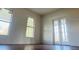 Bright bedroom featuring double doors, natural light from the windows, and wood flooring at 701 1St Ne St, Fort Meade, FL 33841
