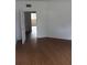 Spacious room with wood floors, offering versatility and a clean aesthetic at 701 1St Ne St, Fort Meade, FL 33841