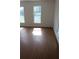 Bedroom filled with natural light, featuring laminate flooring and bright windows at 701 1St Ne St, Fort Meade, FL 33841