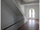 Bright entryway featuring a staircase, white walls, wood floors, and a glass double-door leading to the exterior at 701 1St Ne St, Fort Meade, FL 33841
