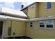 Exterior shot showing the home's siding, windows, and metal roof at 701 1St Ne St, Fort Meade, FL 33841