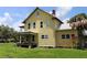 Side exterior view of home with large windows, metal roof and nice yard at 701 1St Ne St, Fort Meade, FL 33841