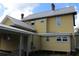 Back exterior view showing home's siding, windows and metal roof at 701 1St Ne St, Fort Meade, FL 33841