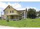 Charming exterior featuring a wraparound porch, large columns and metal roof at 701 1St Ne St, Fort Meade, FL 33841