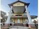 Two-story home featuring a symmetrical front porch and tall white columns with brick supports at 701 1St Ne St, Fort Meade, FL 33841