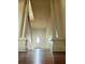 Foyer with high ceilings, large white columns, and a dark wood floor leading to a white front door at 701 1St Ne St, Fort Meade, FL 33841