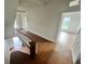 Hallway features hardwood floors, a staircase with a white railing, and natural light coming from the large window at 701 1St Ne St, Fort Meade, FL 33841