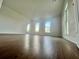 Bright living room with ample natural light from the multiple windows and wood flooring at 701 1St Ne St, Fort Meade, FL 33841