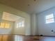 Open-concept living area with wood floors and views into the next room with natural light at 701 1St Ne St, Fort Meade, FL 33841