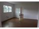 Open living room with natural light, hardwood flooring and two windows at 701 1St Ne St, Fort Meade, FL 33841