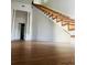 Charming living room featuring hardwood floors and staircase at 701 1St Ne St, Fort Meade, FL 33841