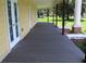 Long open porch features dark wood floors and white trim at 701 1St Ne St, Fort Meade, FL 33841