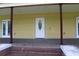 View of front entry with brick steps leading to a painted porch at 701 1St Ne St, Fort Meade, FL 33841