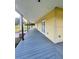 Long front porch with a wood floor, pillars, and views of the lawn at 701 1St Ne St, Fort Meade, FL 33841
