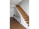Wooden staircase with white risers and a classic railing at 701 1St Ne St, Fort Meade, FL 33841