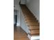 Classic wooden staircase with white trim and detailed banister at 701 1St Ne St, Fort Meade, FL 33841