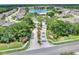 Aerial view of the neighborhood, lake, mature trees, and community entrance at 7770 Lake James Blvd, Lakeland, FL 33810