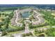 Aerial view of the neighborhood, lake, mature trees, and well-manicured lawns at 7770 Lake James Blvd, Lakeland, FL 33810