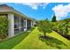 Spacious back yard with lush grass, privacy landscaping, and a screened-in patio at 7770 Lake James Blvd, Lakeland, FL 33810