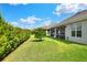 Manicured back yard with plush green grass and privacy hedges at 7770 Lake James Blvd, Lakeland, FL 33810