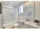 Bright bathroom with a shower over tub, modern vanity, and neutral tile, offering a clean and functional design at 7770 Lake James Blvd, Lakeland, FL 33810