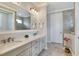 Bathroom featuring double sinks, neutral tile, and glass-door shower at 7770 Lake James Blvd, Lakeland, FL 33810