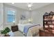 Inviting bedroom with a comfortable bed, vintage furniture, and sunlit window, creating a peaceful retreat at 7770 Lake James Blvd, Lakeland, FL 33810
