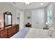 Bedroom featuring a large dresser, closet, and natural light, providing ample storage and a serene atmosphere at 7770 Lake James Blvd, Lakeland, FL 33810