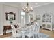 Elegant dining room showcasing decorative mirror, chandelier, comfortable seating, and seamless access to the living space at 7770 Lake James Blvd, Lakeland, FL 33810