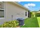 Exterior of the home with lawn, windows, and AC unit surrounded by shrubbery at 7770 Lake James Blvd, Lakeland, FL 33810