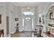 Elegant foyer with a decorative front door, transom window, and an ornate light fixture, complemented by hardwood floors at 7770 Lake James Blvd, Lakeland, FL 33810
