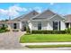 Beautiful single-story home with stone accents, manicured lawn, and a brick-paved driveway in a desirable community at 7770 Lake James Blvd, Lakeland, FL 33810