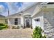 Inviting home exterior featuring stone accents, manicured landscaping, and a brick-paved walkway leading to the front entrance at 7770 Lake James Blvd, Lakeland, FL 33810