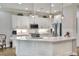Kitchen with white cabinets, breakfast bar, and stainless steel appliances at 7770 Lake James Blvd, Lakeland, FL 33810