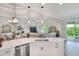 Open-concept living space with island seating, dining area, and sliding glass doors to patio at 7770 Lake James Blvd, Lakeland, FL 33810