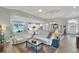 Bright and open living room with tray ceilings, neutral decor, hardwood floors and seamless flow to the kitchen at 7770 Lake James Blvd, Lakeland, FL 33810