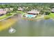 Picturesque community pool next to a lake with fountain and offering covered seating and lounge chairs at 7770 Lake James Blvd, Lakeland, FL 33810