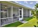 This home features a screened-in lanai with a grill, ceiling fans, and plenty of room for dining and relaxing at 7770 Lake James Blvd, Lakeland, FL 33810
