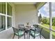 Screened porch with a dining table and chairs, perfect for enjoying meals outdoors in a bug-free environment at 7770 Lake James Blvd, Lakeland, FL 33810