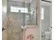 Walk-in shower with window and neutral tile at 7770 Lake James Blvd, Lakeland, FL 33810