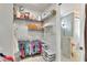 Organized walk-in closet featuring wire shelving and hanging rods for clothes and storage, plus an ensuite bath at 7770 Lake James Blvd, Lakeland, FL 33810