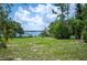 Expansive backyard with mature trees and a serene lake view, perfect for outdoor enjoyment at 783 E Central Ave, Eagle Lake, FL 33839