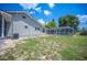 Backyard with a screened-in pool, house, and lush greenery at 783 E Central Ave, Eagle Lake, FL 33839