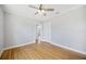 Neutral bedroom featuring wood floors, white trim, a ceiling fan, and a hallway to other rooms at 783 E Central Ave, Eagle Lake, FL 33839