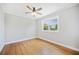 Bright bedroom featuring hardwood floors, neutral paint, a modern ceiling fan, and a view to the backyard at 783 E Central Ave, Eagle Lake, FL 33839