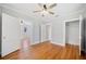 Spacious bedroom featuring wood floors, white trim, a modern ceiling fan, and two closets at 783 E Central Ave, Eagle Lake, FL 33839